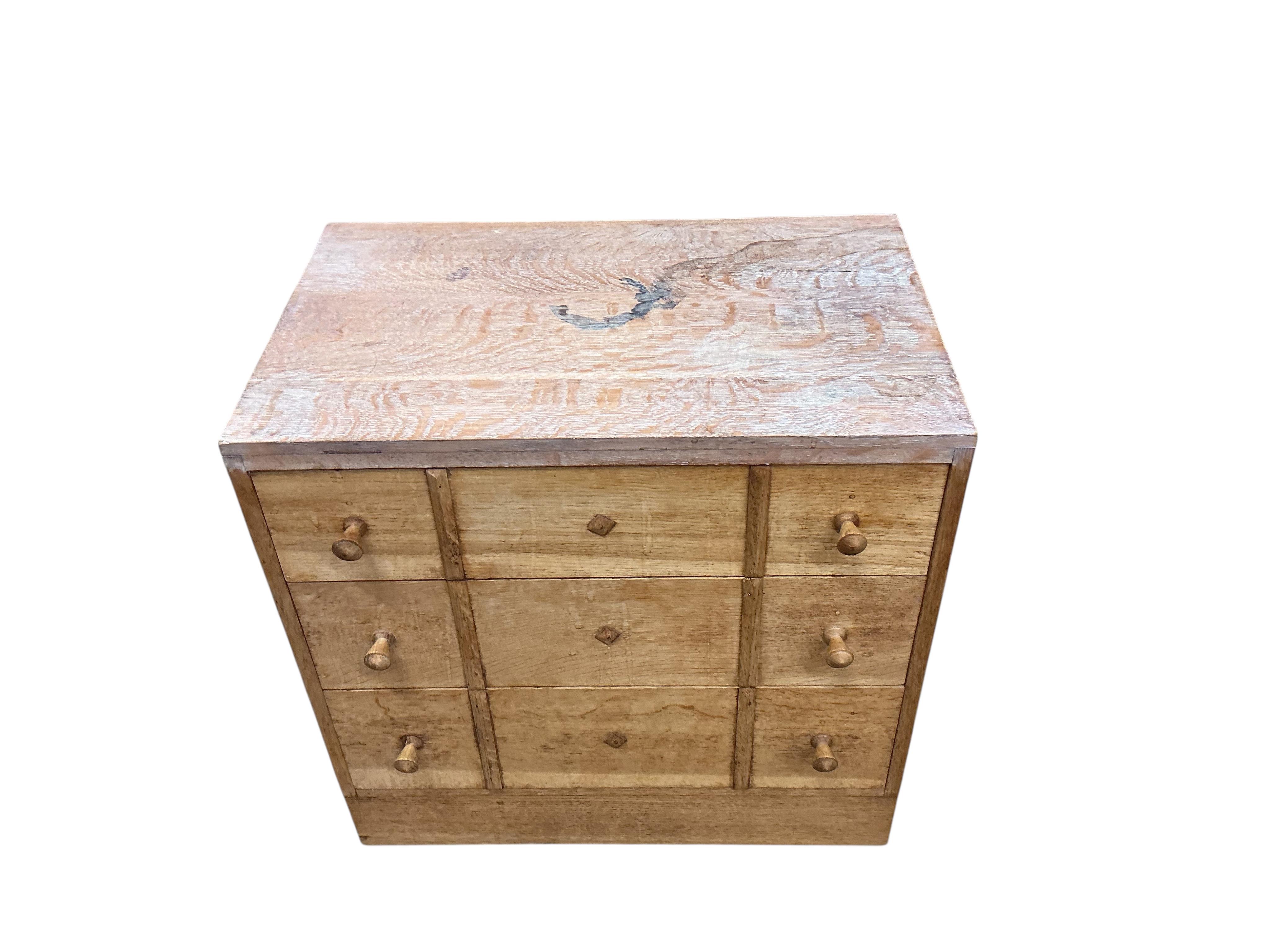 A pair of small limed oak three drawer chests in the manner of Heals, width 68cm, depth 43cm, height 68cm